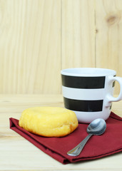 Fresh donut with a coffee cup on wooden table backgrounds vertical side views