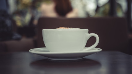 White porcelain cup of hot coffee