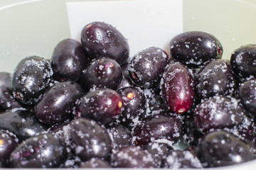 Syzygium cumini fruit with salt in the plastic container