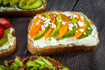 Delicious toast with avocado, apricot, feta cheese