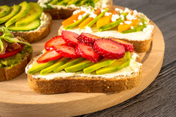 Variation of healthy rye breakfast sandwiches with avocado and with different ingredients