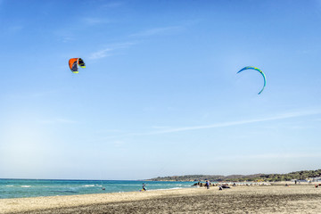 Kite surfers on calm italian beach, Puglia
