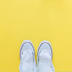 fashion white sneakers or boots without laces on yellow background. fashion minimal