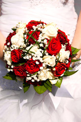 Bridal bouquet. The bride's . Beautiful of white flowers and greenery, decorated with silk ribbon, lies on vintage wooden chair