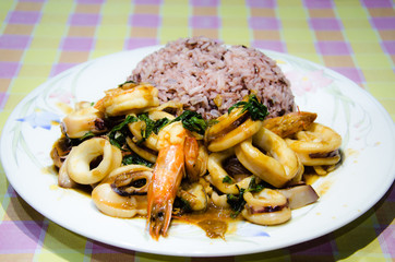 Fried basil leave with seafood on rice