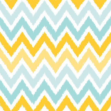 Seamless geometric pattern, based on ikat fabric style. Vector illustration. Carpet rug texture vector imitation. Yellow and gray chevron pattern.