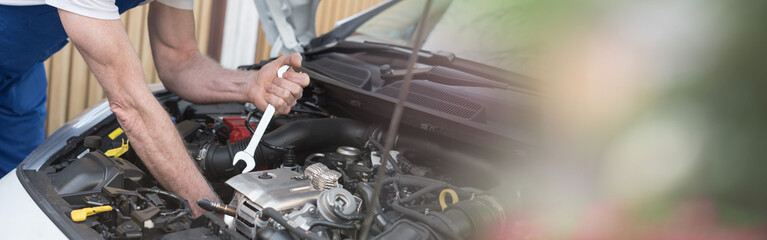 Car mechanic working on car engine