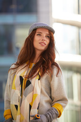 Portrait of beautiful brunette girl walking the street . Smiling. Urban city scene. Warm sunny weather. Outdoors