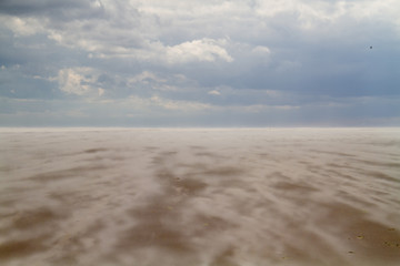 Shifting sand on a beach on a stormy day