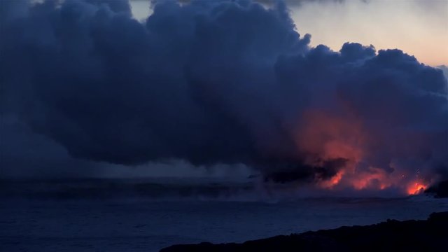 Lava flows into the ocean at night. Kilauea Volcano, Hawaii Big Island, USA.