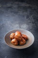 Traditional Japanese Umeboshi as close-up in a bowl