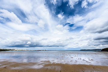 Atlantic sandy beach in Spain with city of Coruna background.