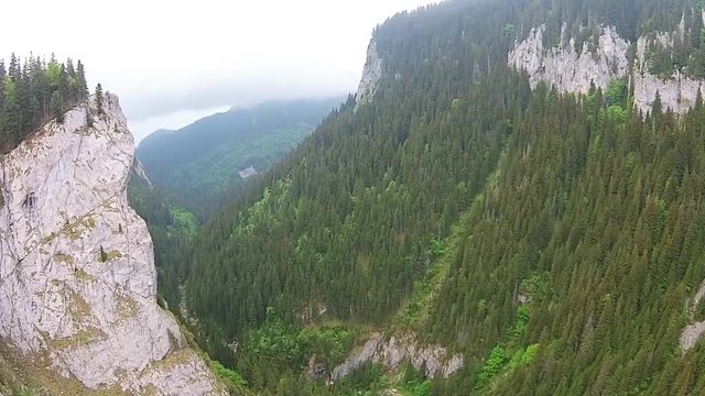 Aerial drone shot through  spectacular  canyon of limestone shale conglomerate rocks , alpine landscape in the Zanoaga Gorge , Bucegi Natural Park , Carpathian Mountains, Romania