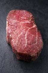 Dry aged raw Wagyu Point Steak as close-up on a slate