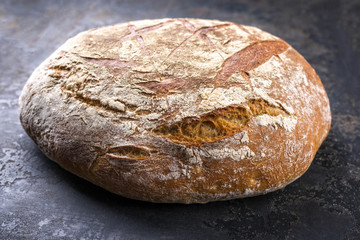 Freshly backed Farmhouse Bread as close-up on an old griddle