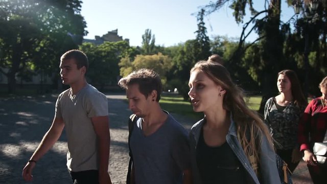 Smiling students going to lecture at college