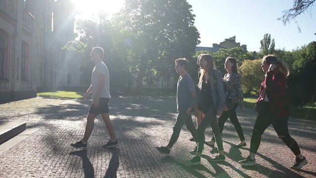 Group of students entering university building