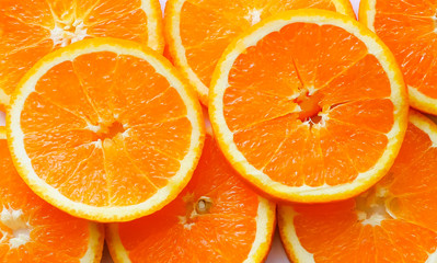 Pile of bright sliced oranges on white background