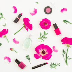 Obraz na płótnie Canvas Fashion blogger desk with cosmetics - lipstick, eye shadows, nail polish and pink flowers on white background. Flat lay, top view.