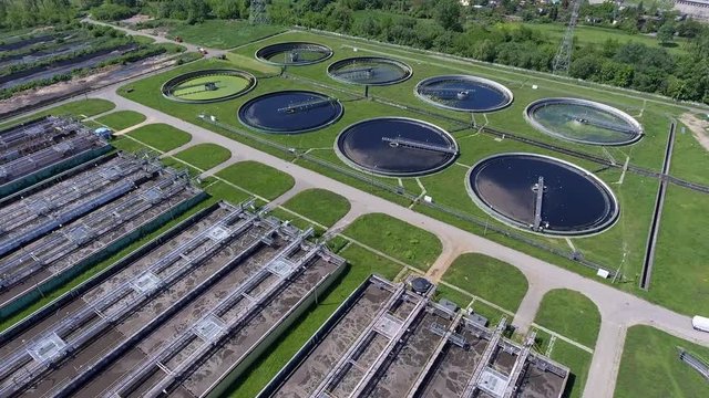 Sewage farm. Static aerial photo looking down onto the clarifying tanks and green grass.