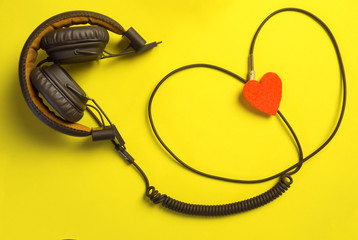 headphones and heart. the concept musical. yellow beautiful background