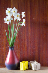 Bouquet of white daffodils in a ceramic vase. Romantic gifts. Spring Flowers. Narcissus on wooden background.
