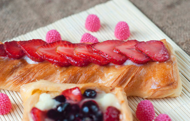 Pastries with berries on a wooden background. Summer fruit dessert