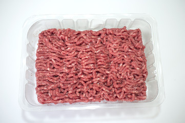 Package with fresh minced meat over a white background
