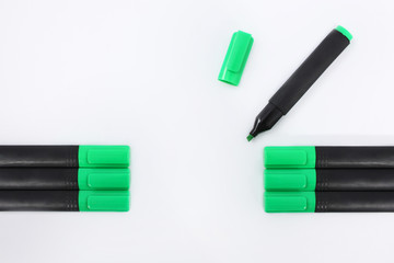 Green markers on a white background