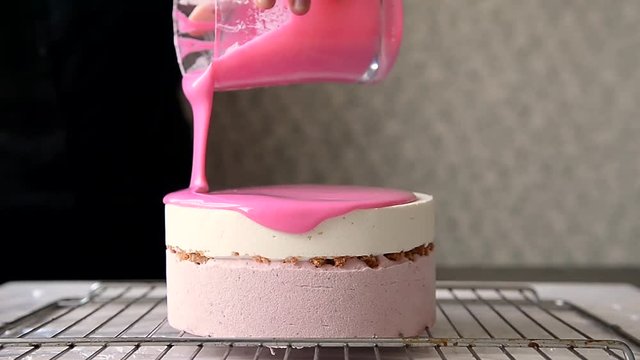 The process of casting the mirror glaze on a cake round session. Mousse.Pink