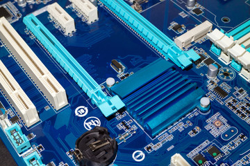 A computer desktop mainboard with electronic components closeup