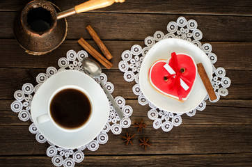 Cozy holiday. Mug coffee, heart shaped gingerbread, cezve. Top view