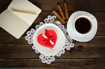 Cozy holiday. Mug coffee, notepad and pencil, spices. Top view