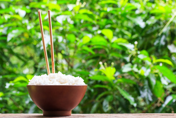Close up rice in wooden bowl on wooden table , selective focus.