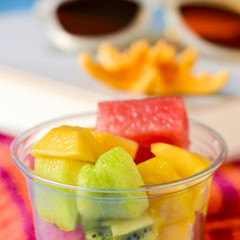 fruit salad, sunglasses, book and starfish