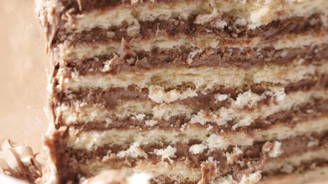 Creamy layers of chocolate cake on the plate slow tilt 4K 2160p 30fps UltraHD footage - Rich and tasty multilayered torte with biscuits 3840X2160 UHD tilting video 