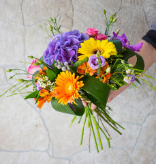 florist in hands bright sunny summer bouquet for a beautiful girl and a woman, a gift for the holiday
