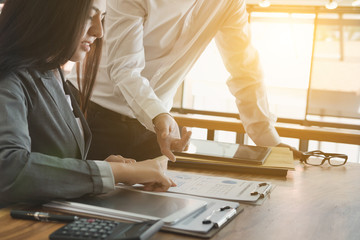 Businesswoman working with businessman. two business people discussing document and idea at meeting. Woman consulting her colleague in office.