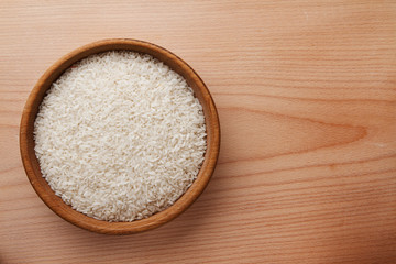 Raw rice in wooden bowl