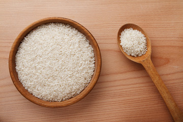 Raw rice in wooden bowl