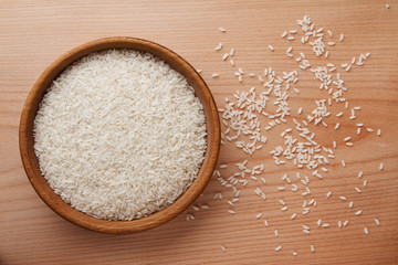 Raw rice in wooden bowl