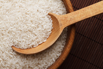 Raw rice in wooden bowl