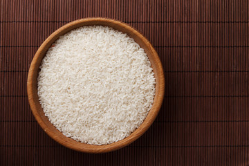 Raw rice in wooden bowl