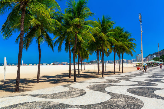 Copacabana with palms and mosaic of sidewalk in Rio de Janeiro. Brazil