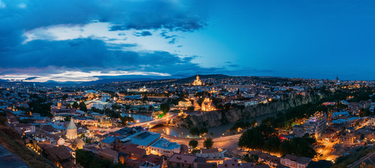 Tbilisi Georgia. Scenic Panoramic Top View Of Cityscape In Evening Bright Illumination