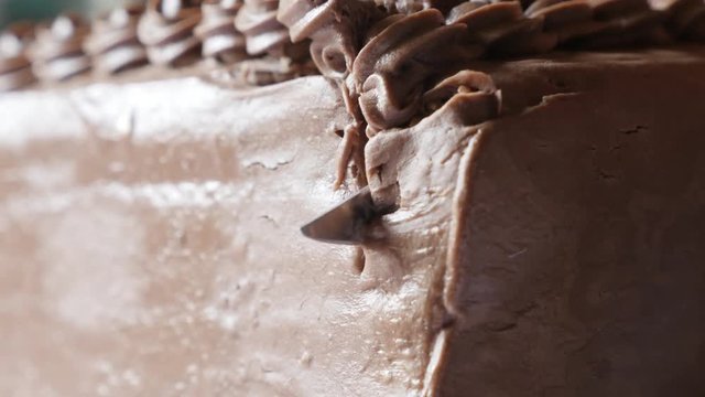 Cutting on pieces multilayered torte with biscuits 4K 2160p 30fps UltraHD footage - Knife using for chocolate cake close-up 3840X2160 UHD video 