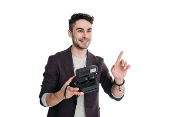 smiling man taking photo with instant vintage camera isolated on white