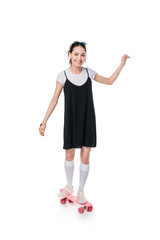 casual asian girl riding on skateboard isolated on white