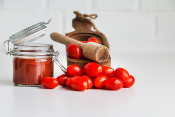 Cherry tomatoes, chopped crushed tomatoes on wooden table. Copy space. Top view.