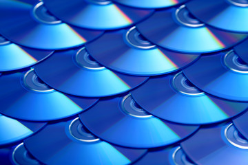 Compact discs background. Several cd dvd blu-ray discs. Optical recordable or rewritable digital data storage.